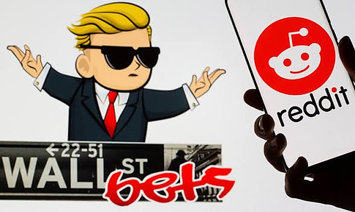 The r/wallstreetbets mascot in a black suit, white shirt and red tie with sunglasses and palms out, beside a Wall St Bets street sign and the Reddit logo on a phone.